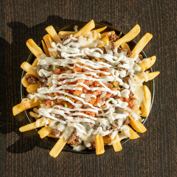 Mexican fries loaded with ground beef, melted cheese, pico de gallo, and a drizzle of white sauce.